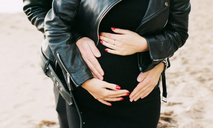 man-in-black-leather-zip-jacket-hugging-woman-in-black-704960