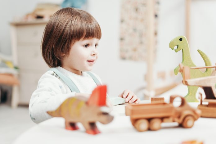 boy-in-white-long-sleeve-top-playing-with-toy-3661284