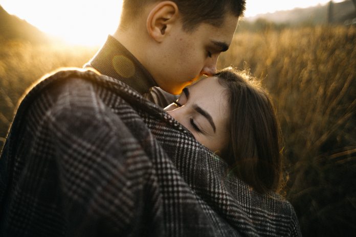 man-wearing-grey-shirt-hugging-woman-outside-ner-crops-3373366